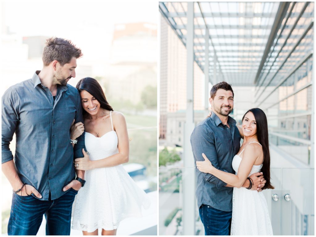 An engaged couple posing on top of the Hilton Hotel for their downtown Cleveland engagement session