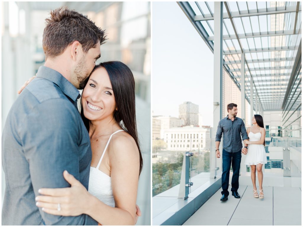 An engaged couple posing on top of the Hilton Hotel for their downtown Cleveland engagement session