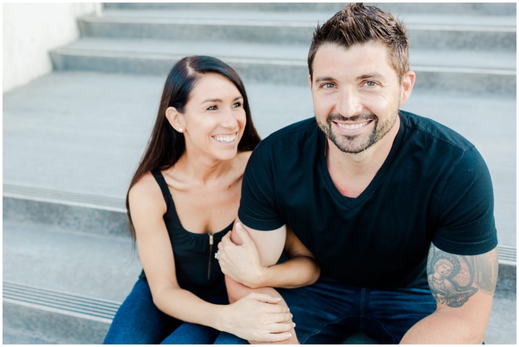 An engaged couple posing on top of the Hilton Hotel for their downtown Cleveland engagement session