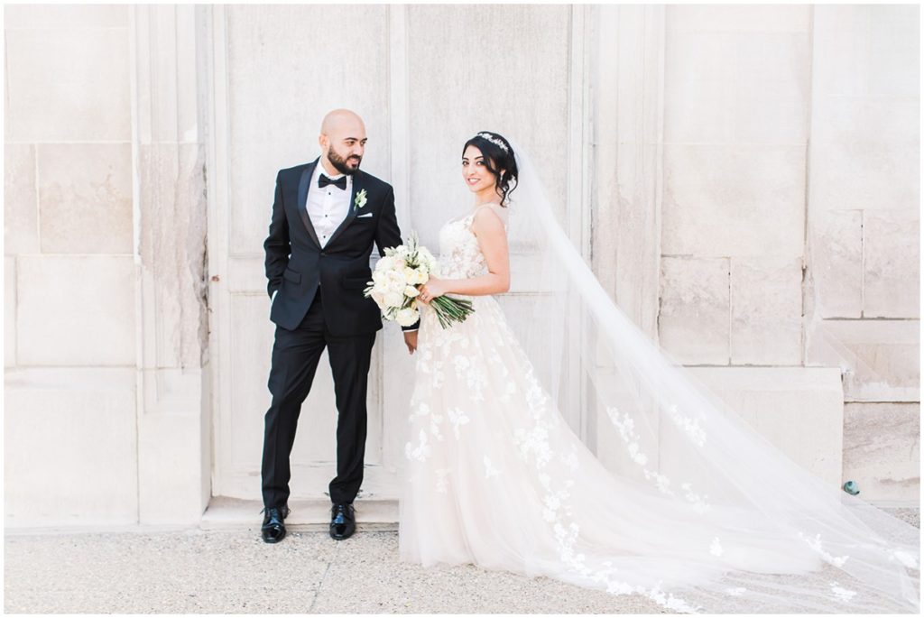 A bride and groom embracing each other for their wedding portraits at the Club at Hillbrook