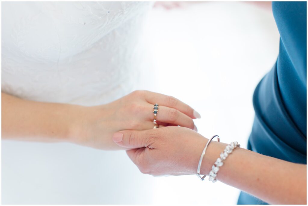 a bride and her mom embracing each other on her wedding day at Tudor house at mason's cove