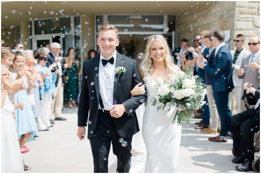 bride and groom walking out of their ceremony