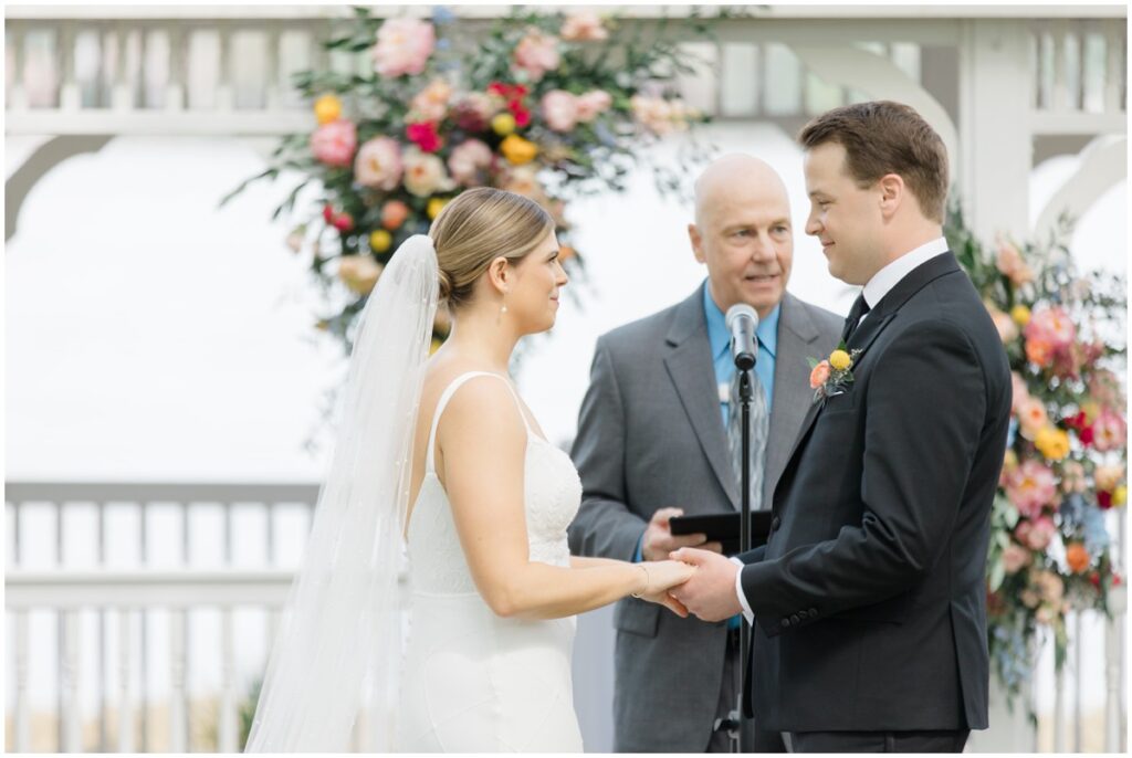 a bride and groom saying their vows during their Tudor house at mason's cove wedding