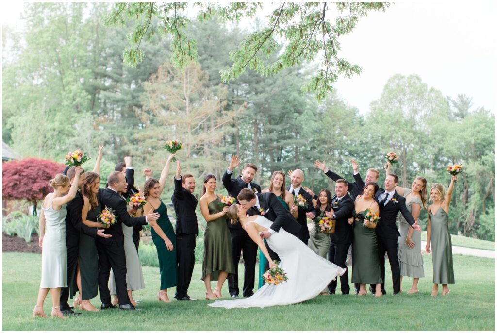 a wedding party celebrating a newly married couple at the Tudor house at mason's cove wedding venue