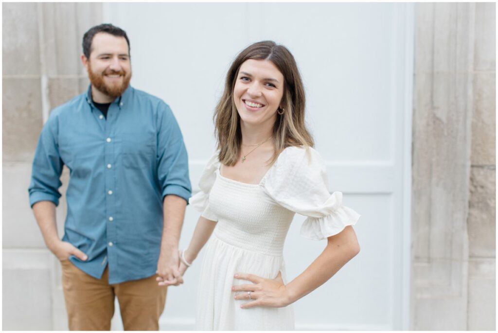 a couple posing and smiling at the camera for their downtown chagrin falls engagement session