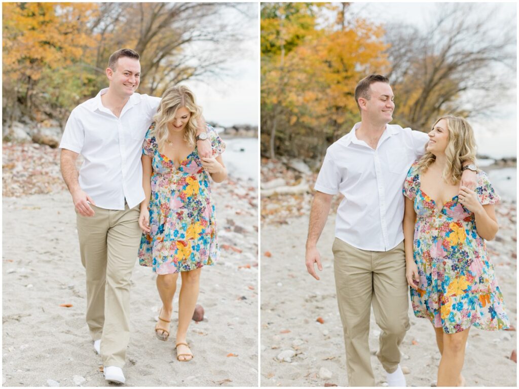 An engaged couple walking along Edgewater park for their engagement session