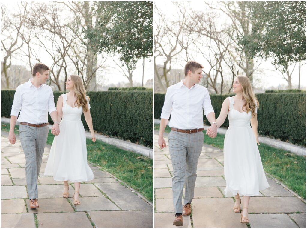 An engaged couple walking and smiling at each other during their engagement session at the Cleveland Museum of Art