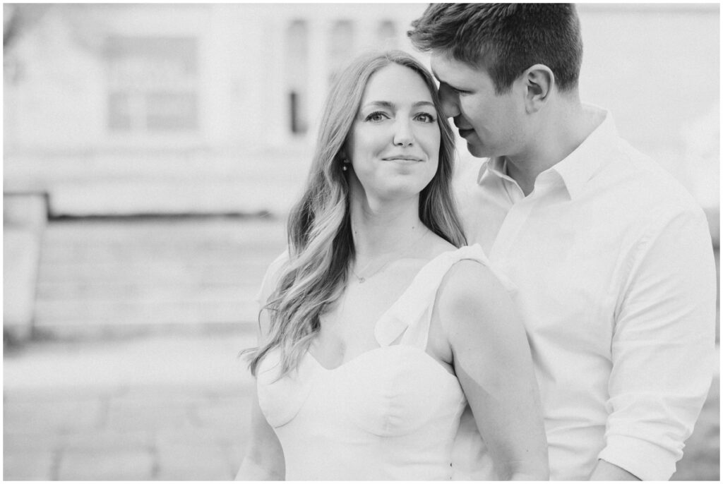 A couple embracing each other in front of the Cleveland Museum of Art for their engagement session