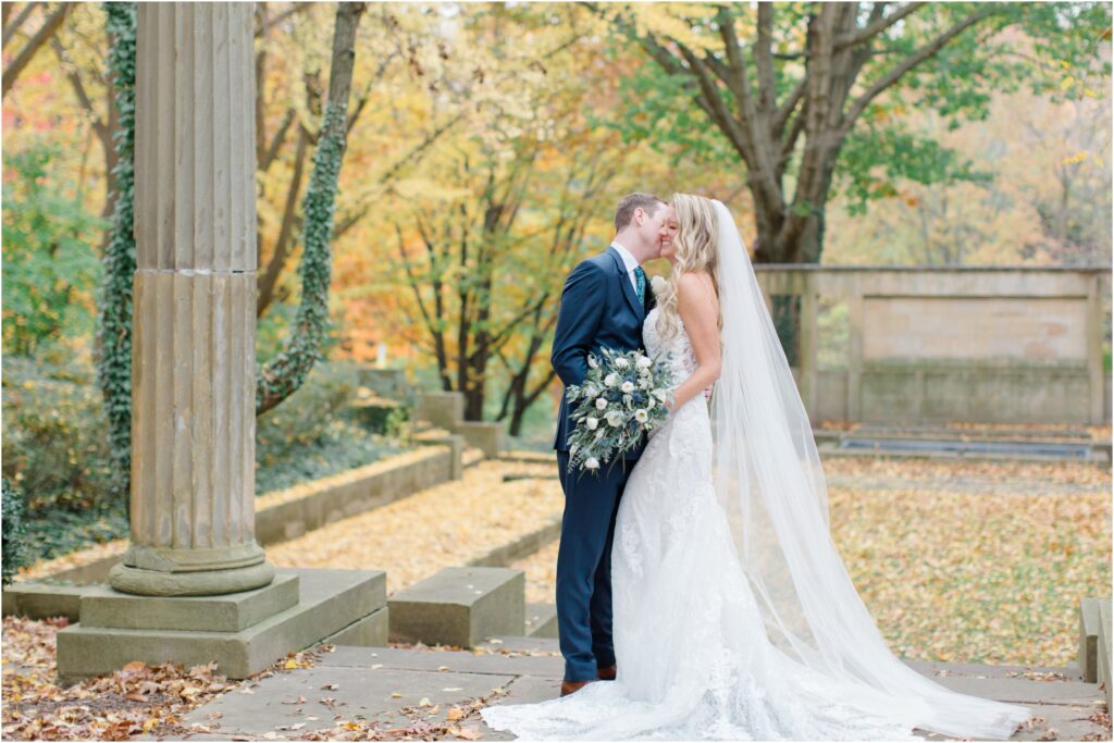 A bride and groom laughing at the Greek cultural gardens in Cleveland Ohio