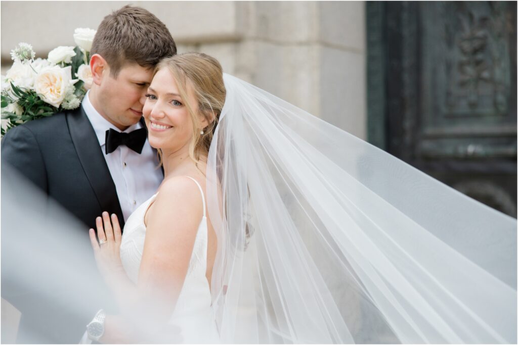 A couple posing for their wedding photos in front of the Old Courthouse in Cleveland, Ohio.