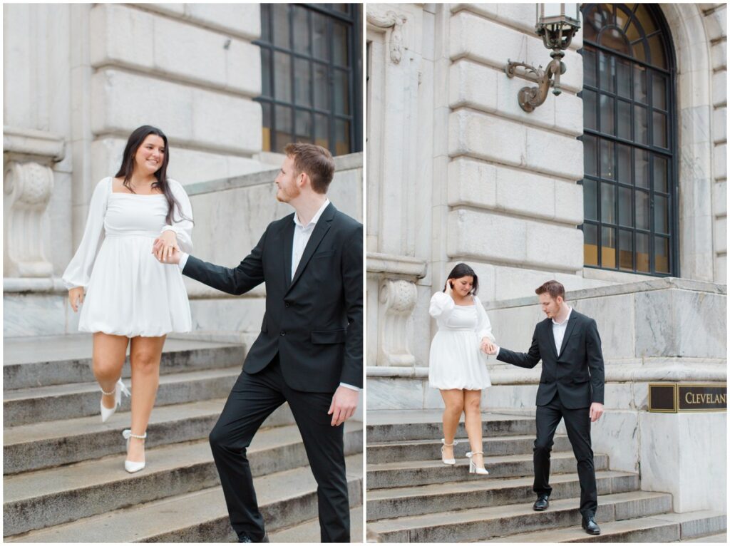 A couple holding hands walking down the steps of the Cleveland Public Library during their engagement session.