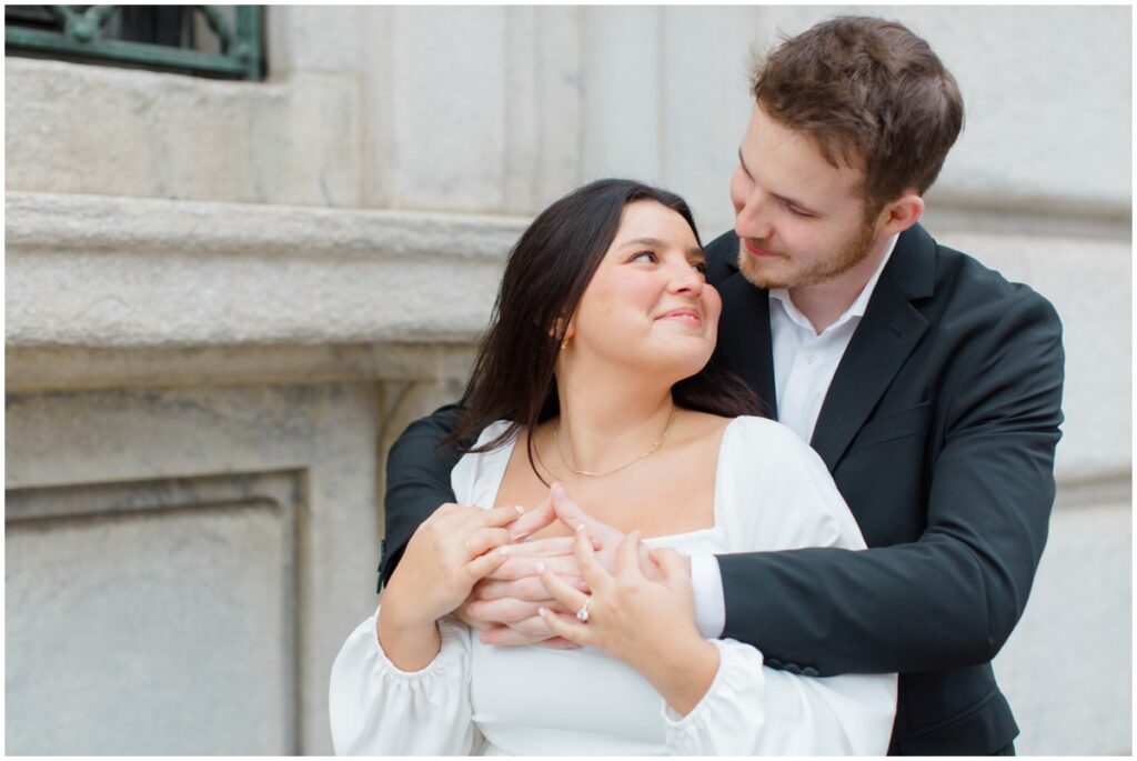 A couple embracing each other for their engagement session in downtown cleveland