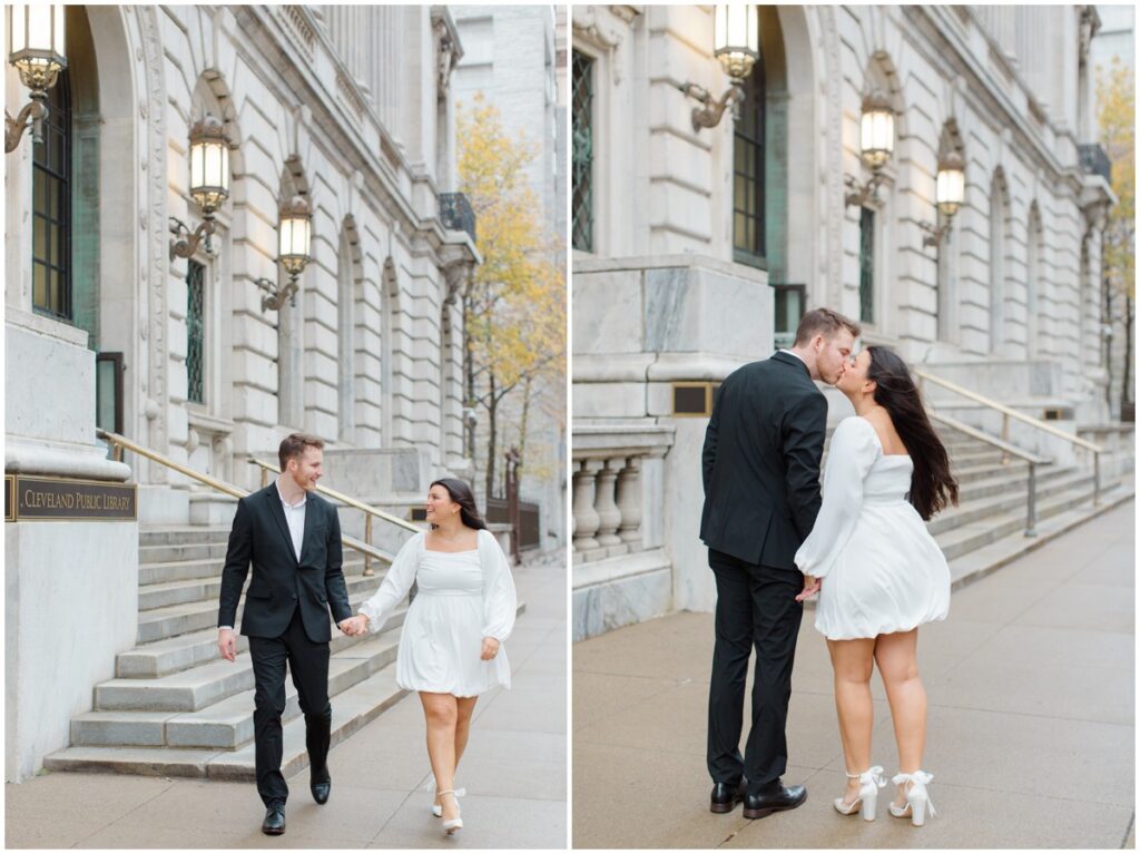 a couple holding hands and walking for their engagement session photos in front of the Cleveland Public Library