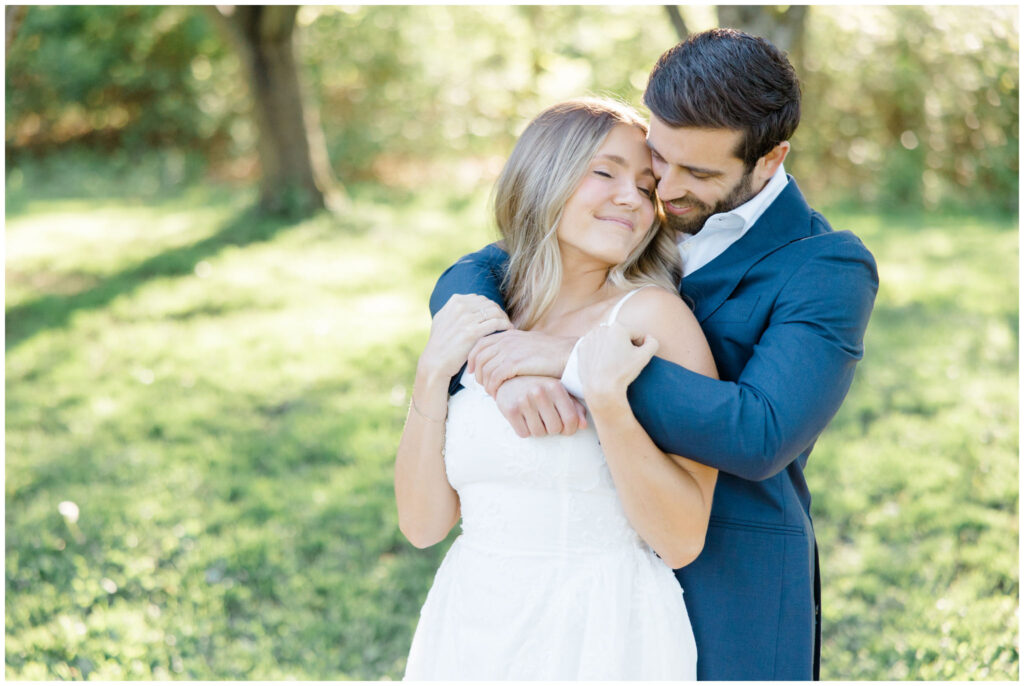 A couple embracing themselves for their engagement session in Akron Ohio.