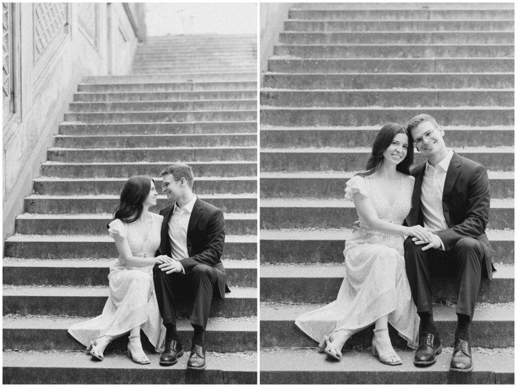 A black and white photo of a couple sitting on steps in Central Park for their New York City engagement session