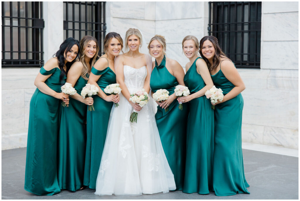 bridesmaids scrunched together smiling 