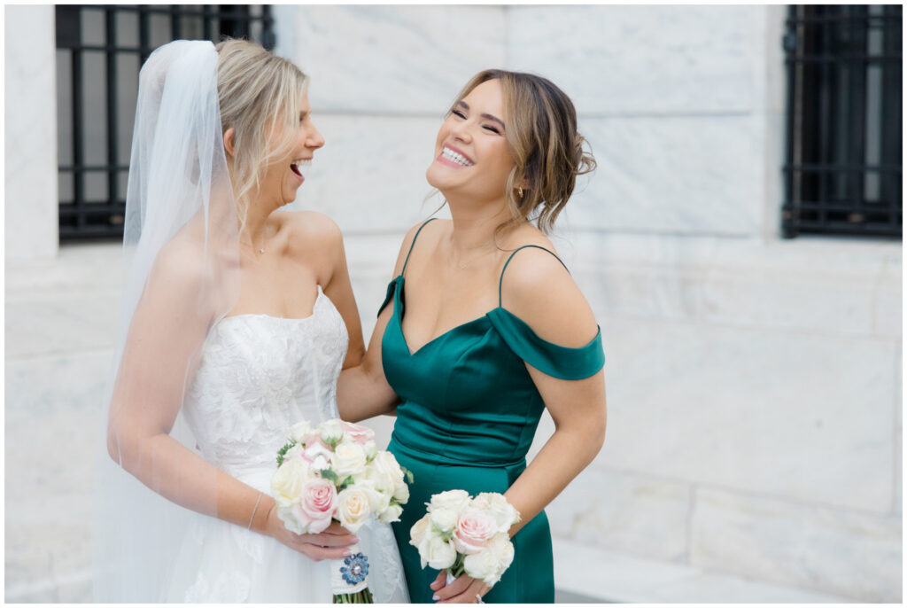 bride smiling and laughing with her bridesmaid