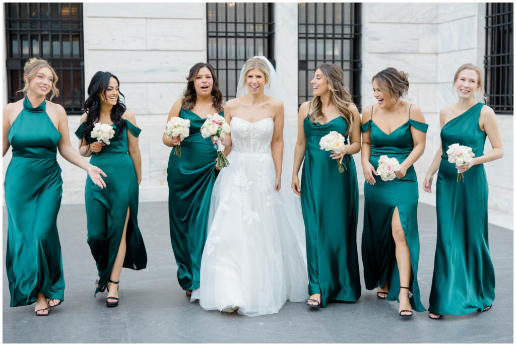 bride walking with her bridesmaids inside the cleveland museum of art