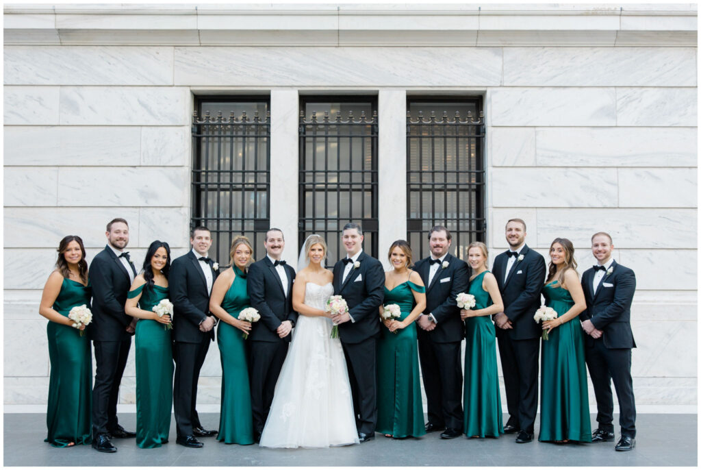 Wedding party posing inside the atrium of the cleveland museum of art