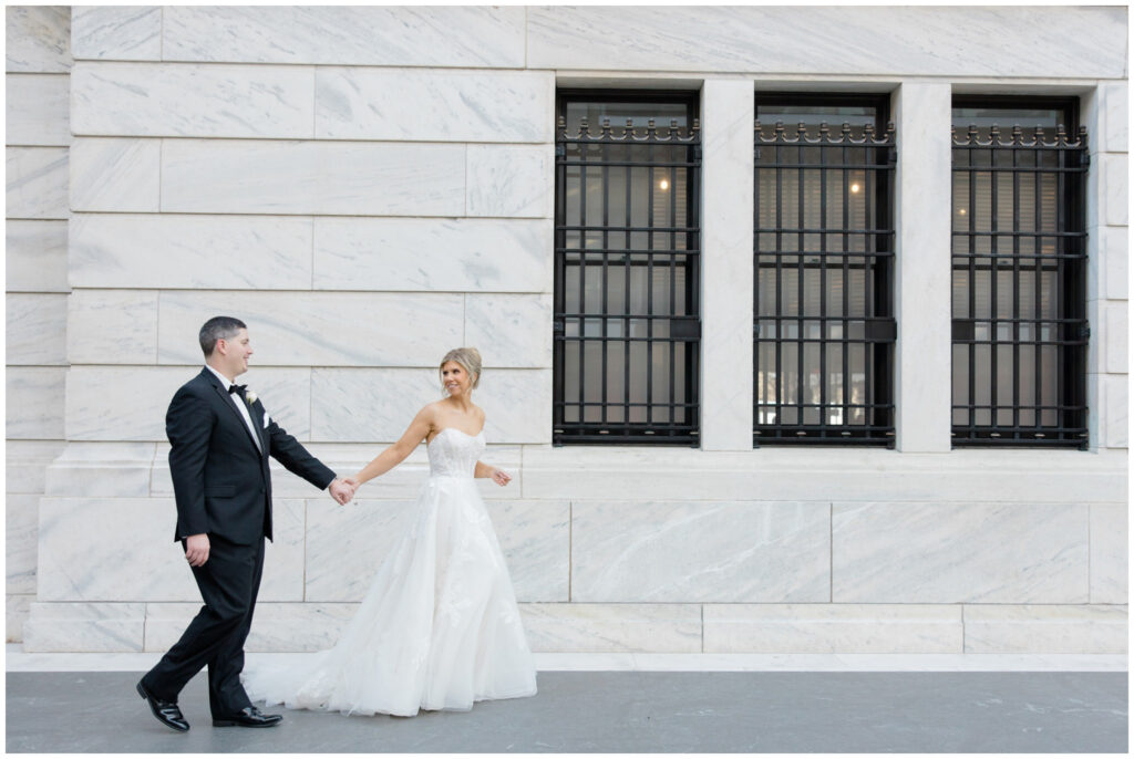 a couple posing for their wedding portraits at the cleveland museum of art