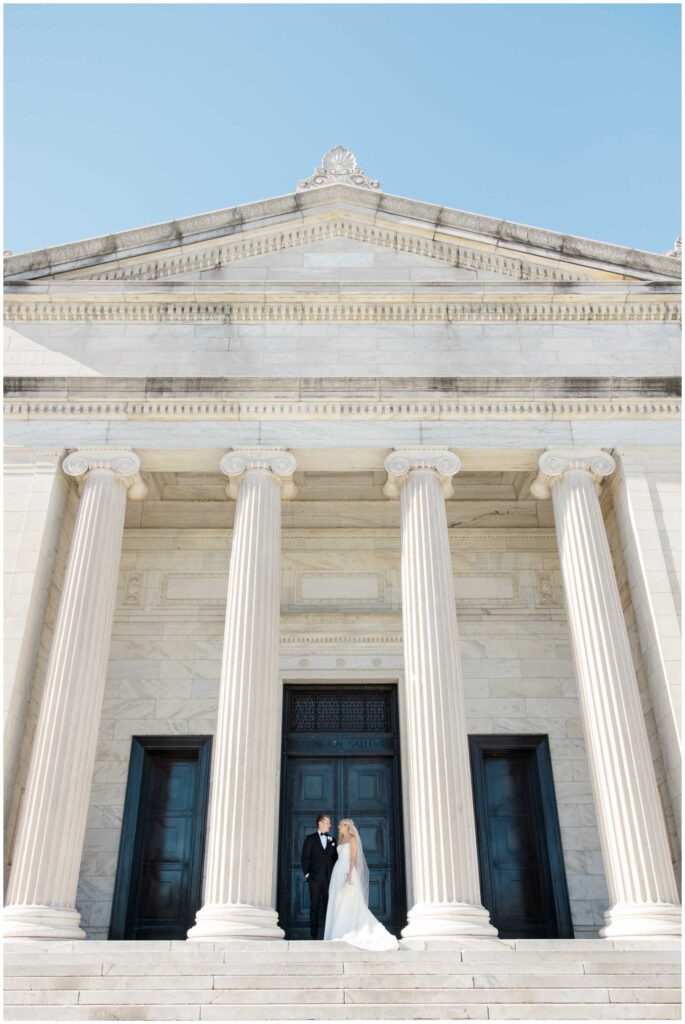 A couple posing for their wedding portraits at the Cleveland Museum of Art